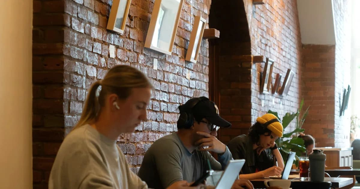 Cafe manager reviewing an employee schedule template on a laptop