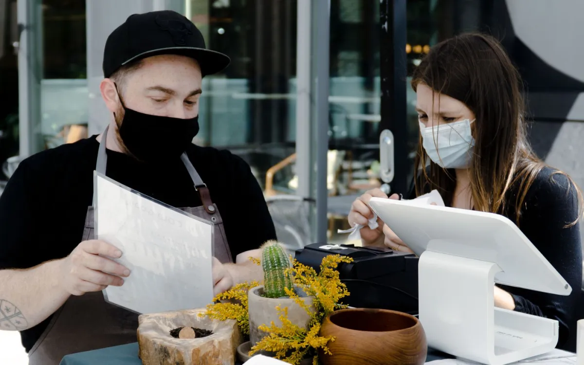 Employés de restaurant vérifiant une source de pourboires près de la caisse