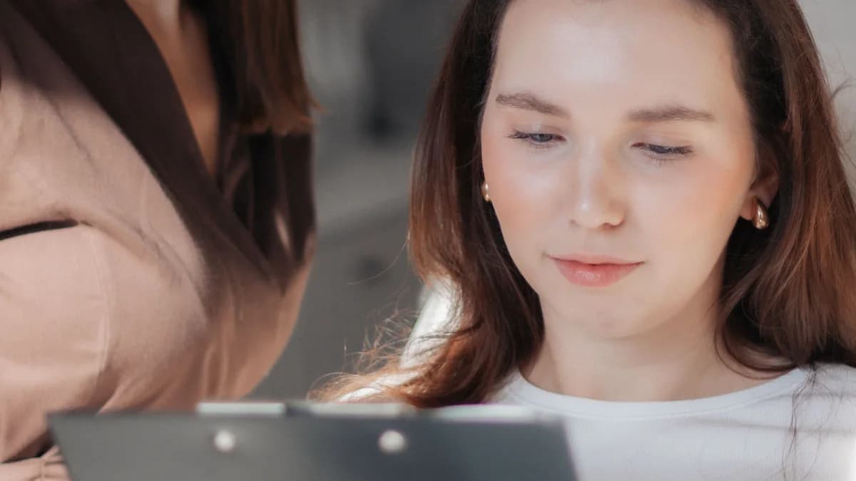 Two coworkers reviewing a written schedule and staffing notes