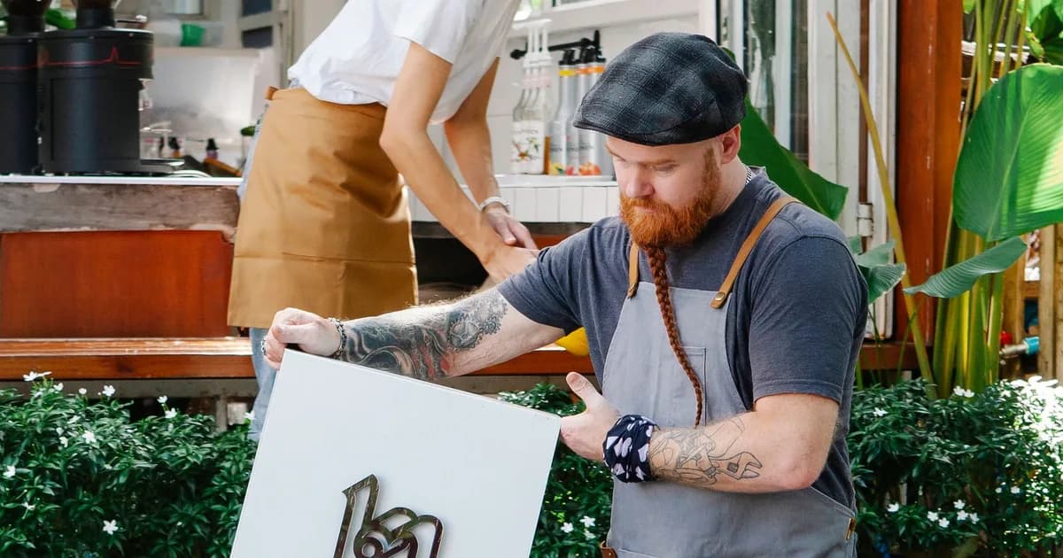 Cafe staff setting up an outdoor sign before opening